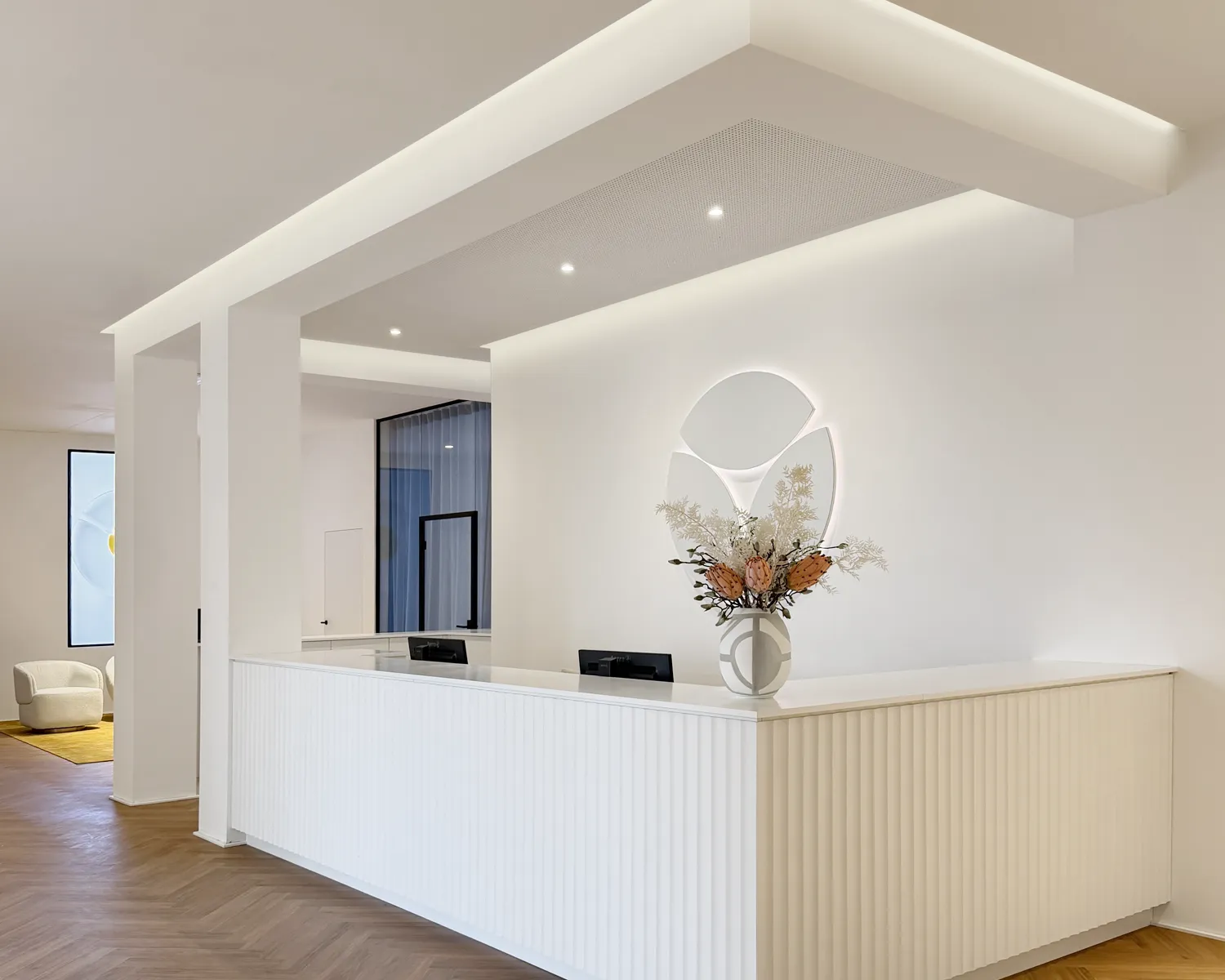 Heller Empfangsbereich mit weißer Empfangstheke im INUA Zentrum für Gynäkologie, Funktionelle Medizin und natürliche Ästhetik in Stuttgart-Möhringen.
